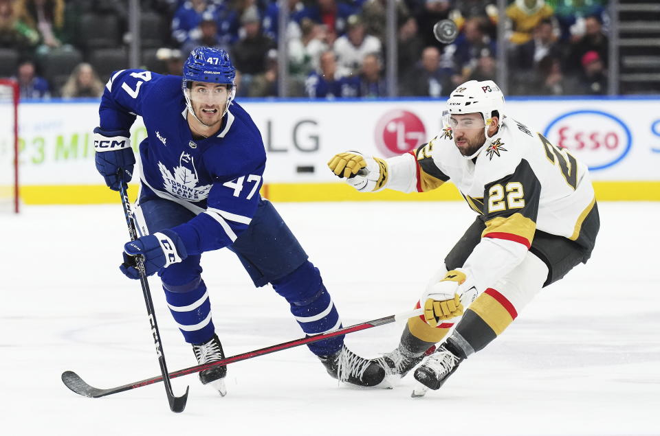 Toronto Maple Leafs forward Pierre Engvall (47) and Vegas Golden Knights forward Michael Amadio (22) chase the puck during the second period of an NHL hockey game, Tuesday, Nov. 8, 2022 in Toronto. (Nathan Denette/The Canadian Press via AP)