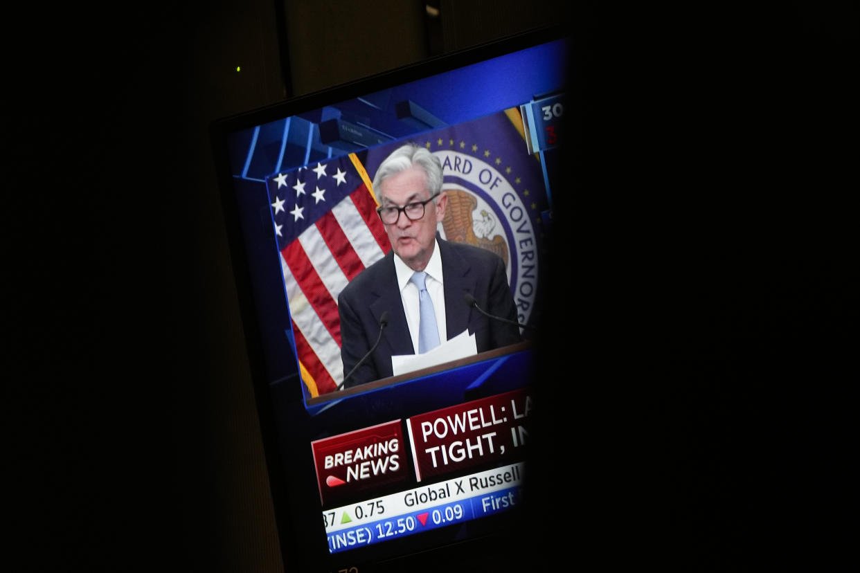 File - A monitor displays Federal Reserve Chairman Jerome Powell's news conference while traders work on the floor at the New York Stock Exchange in New York, Wednesday, March 22, 2023. The Federal Reserve is on track to raise its benchmark interest rate for the 10th time on Wednesday, the latest step in its yearlong effort to curb inflation with the fastest pace of hikes in four decades. (AP Photo/Seth Wenig, File)