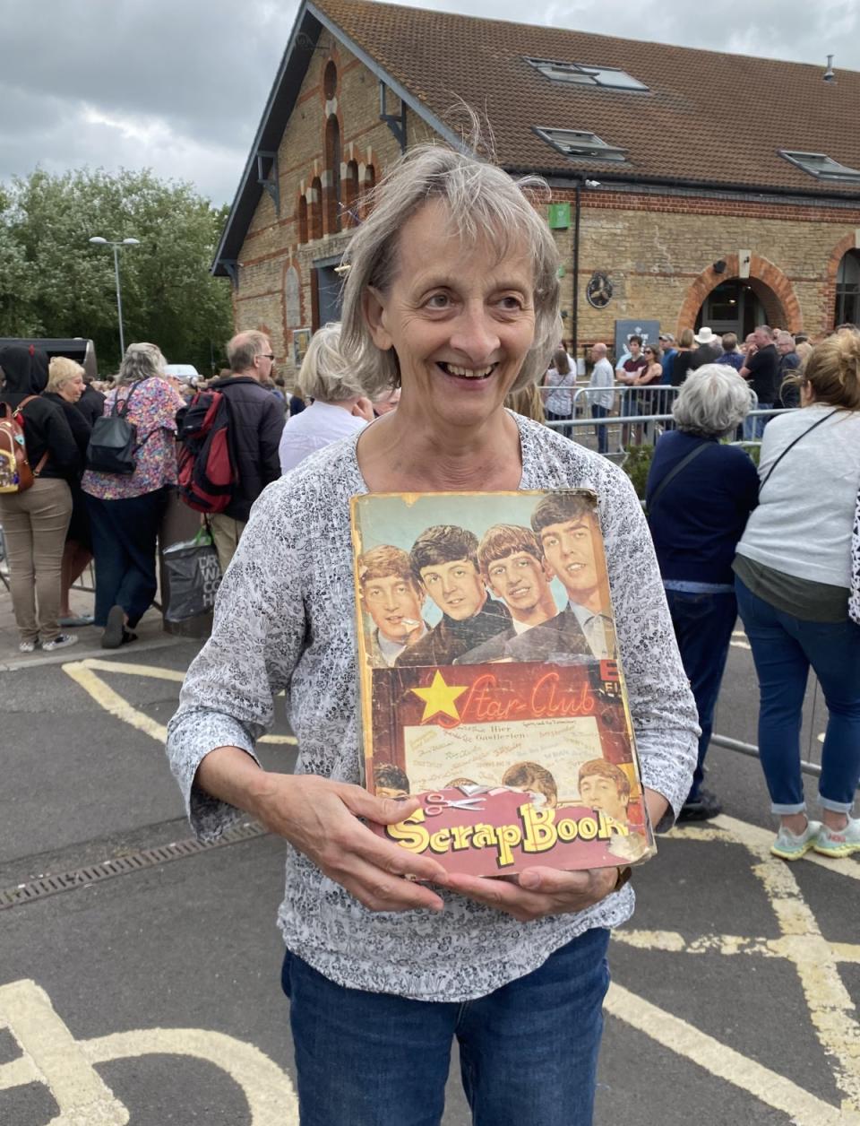 Superfan Jane Lamb waited outside the venue with her Beatles scrapbook which she had made aged eight (Connie Evans/PA) (PA Wire)