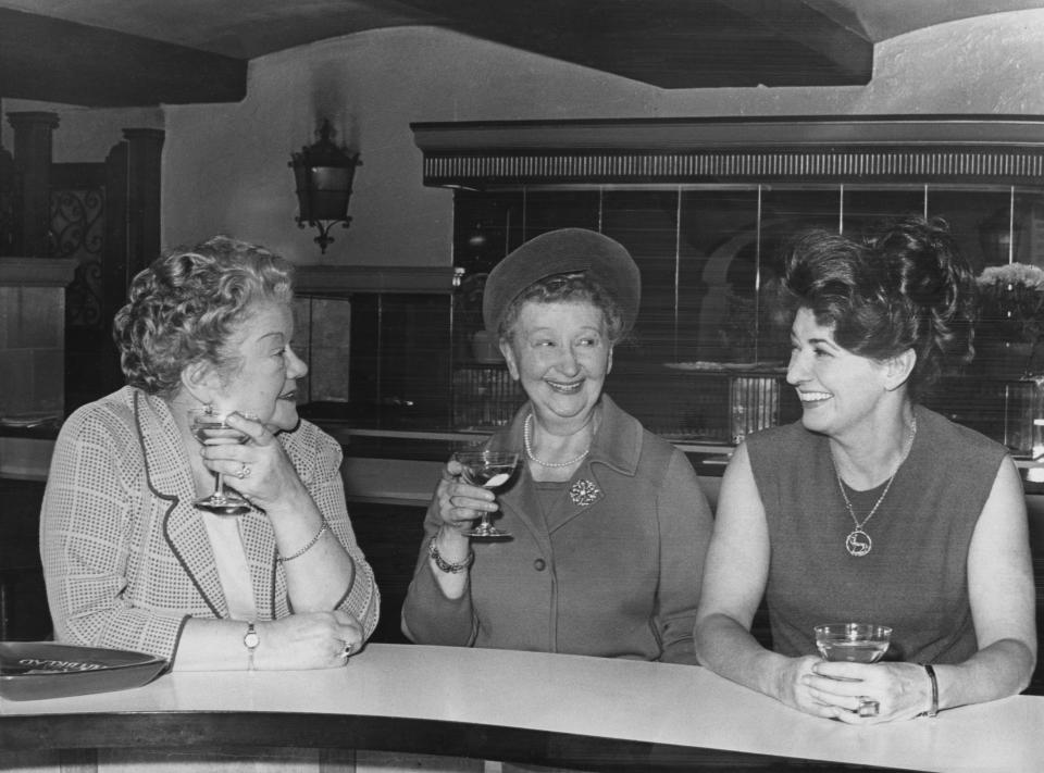 From left to right, 'Coronation Street' actresses Violet Carson (Ena Sharples), Margot Bryant (Minnie Caldwell) and Pat Phoenix (Elsie Tanner) take a break during rehearsals for the 'Royal Gala' show at the London Palladium, 28th November 1966. The show is scheduled for the next day, and is in aid of the Cinematograph and TV Benevolent Fund. (Photo by Gary Weaser/Keystone/Hulton Archive/Getty Images)