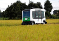 Robot Shuttle, a driver-less, self driving bus, developed by Japan's internet commerce and mobile games provider DeNA Co., drives past between rice stalk during an experimental trial with a self-driving bus in a community in Nishikata town, Tochigi Prefecture, Japan September 8, 2017. REUTERS/Issei Kato