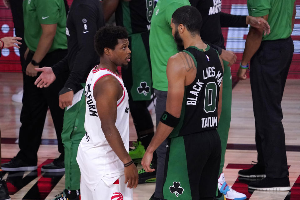 Kyle Lowry, left, shares a word with the Celtics' Jayson Tatum after Game 7 Friday night. (AP Photo/Mark J. Terrill)