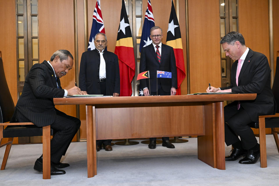 Australian Prime Minister Anthony Albanese, second right, and East Timor's President Jose Ramos-Horta, second left, attend a signing ceremony between East Timor's Defense Minister Filomeno Paixao de Jesus and Australian Defense Minister Richard Marles, right, at Parliament House in Canberra, Australia, Wednesday, Sept. 7, 2022. Ramos-Horta is on an official visit to Australia. (Lukas Coch/AAP Image via AP)