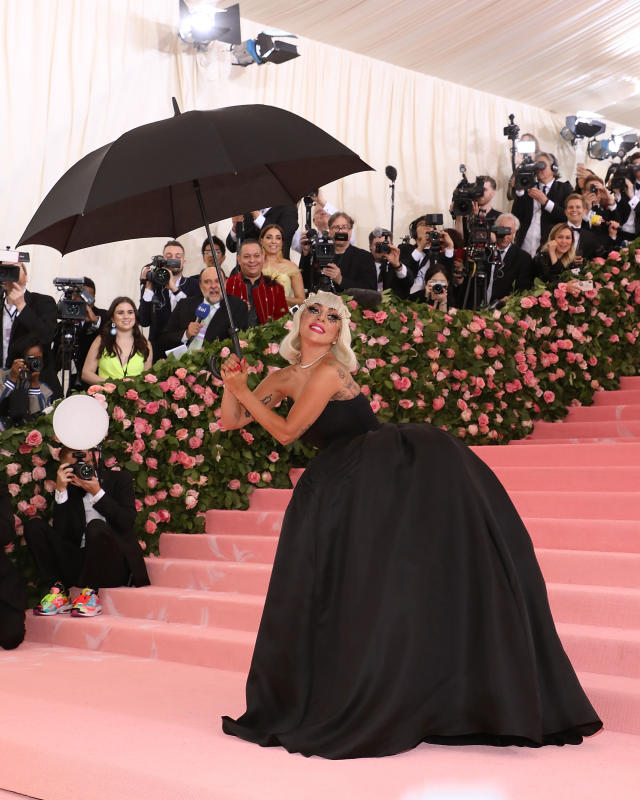 Lady Gaga in a black dress holding a black umbrella at the Met Gala