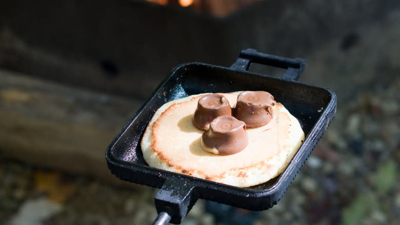 pie iron filled with dough and chocolate