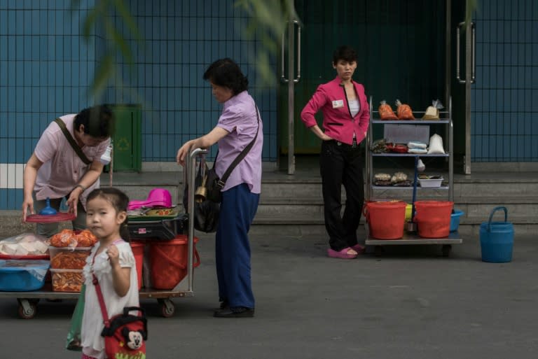 Street vendors wait for customers in Pyongyang, where economic change is quietly taking place, even as North Korean authorities insist the philosophy of founder Kim Il-Sung remains the rule