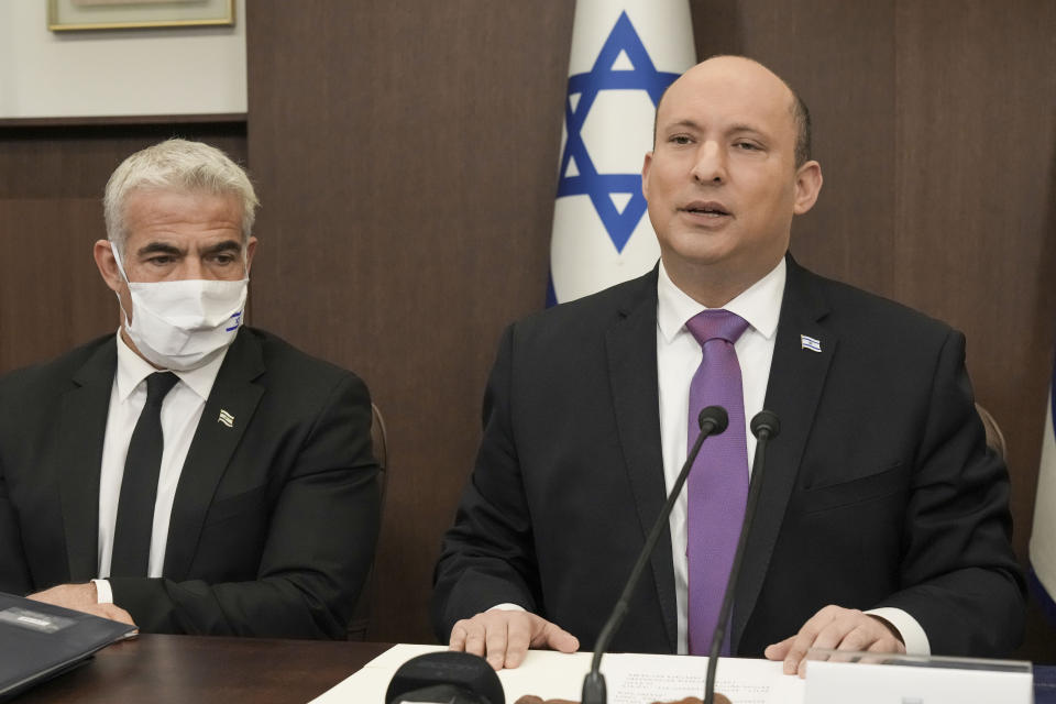 Israeli Prime Minister Naftali Bennett, right, chairs the weekly cabinet with Israeli Foreign Minister Yair Lapid in Jerusalem, Sunday, Feb. 20, 2022. (AP Photo/Tsafrir Abayov, Pool)
