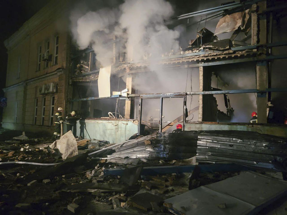In this photo provided by Odesa City Administration, Ukrainian emergency workers examine the site of the Russian rocket attack in central Odesa, Ukraine, early hours Monday, Nov. 6, 2023. (Odesa City Administration via AP)