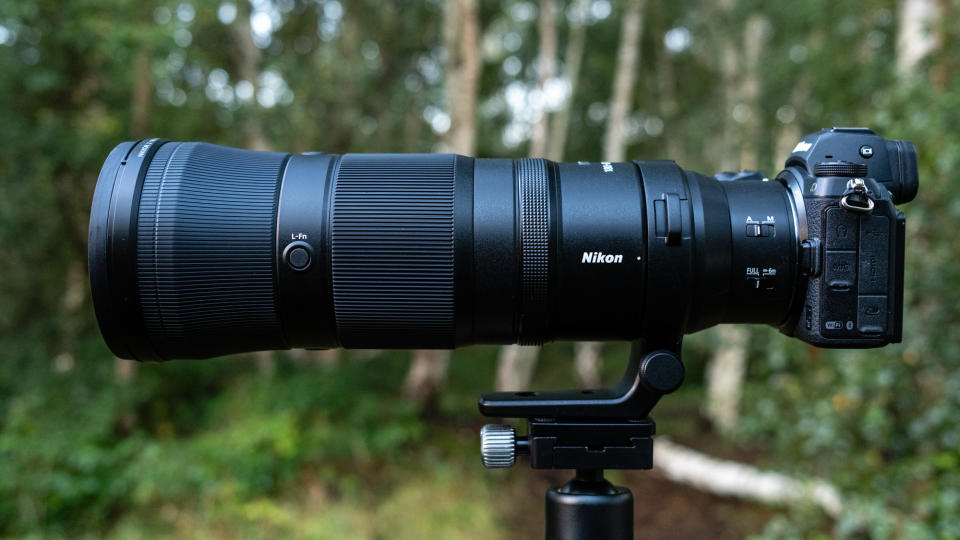 Close up photos of the Nikkor Z 180-600mm f/5.6-6.3 VR mounted on a tripod with foliage in the background