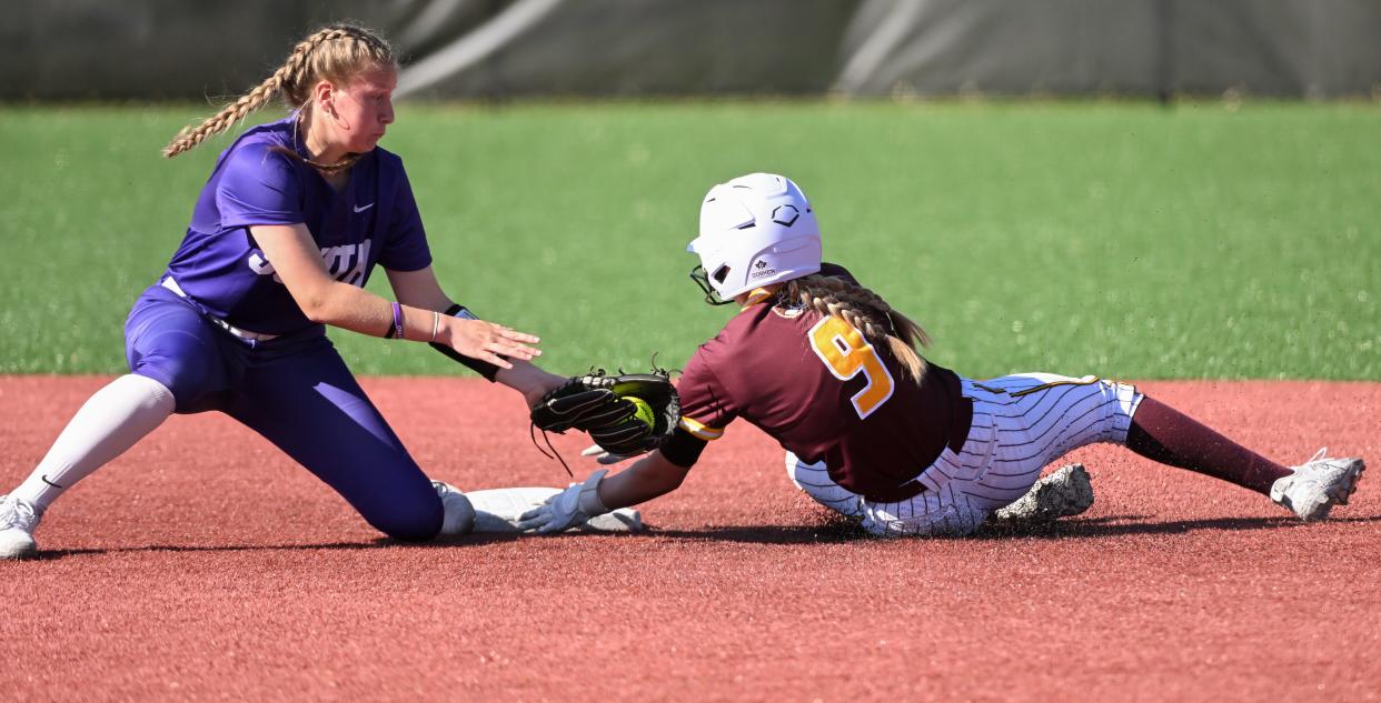 Bloomington North’s Molly Klein (9) steals second base as Bloomington South’s Morgan Cockerill looks to make the tag during the softball game at South on Wednesday, April 24, 2024.