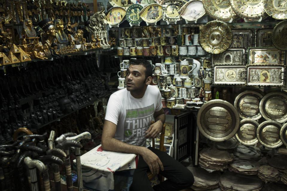 Romi, 26, waits for customers in his souvenir shop in the Khan El-Khalili market, normally a popular tourist destination, in Cairo, Egypt, Wednesday, Aug. 21, 2013. Riots and killings that erupted across the country after the crackdown against followers of ousted President Mohammed Morsi have delivered a severe blow to Egypt's tourism industry, which until recently accounted for more than 11 percent of the country's gross domestic product and nearly 20 percent of its foreign currency revenues. (AP Photo/Manu Brabo)