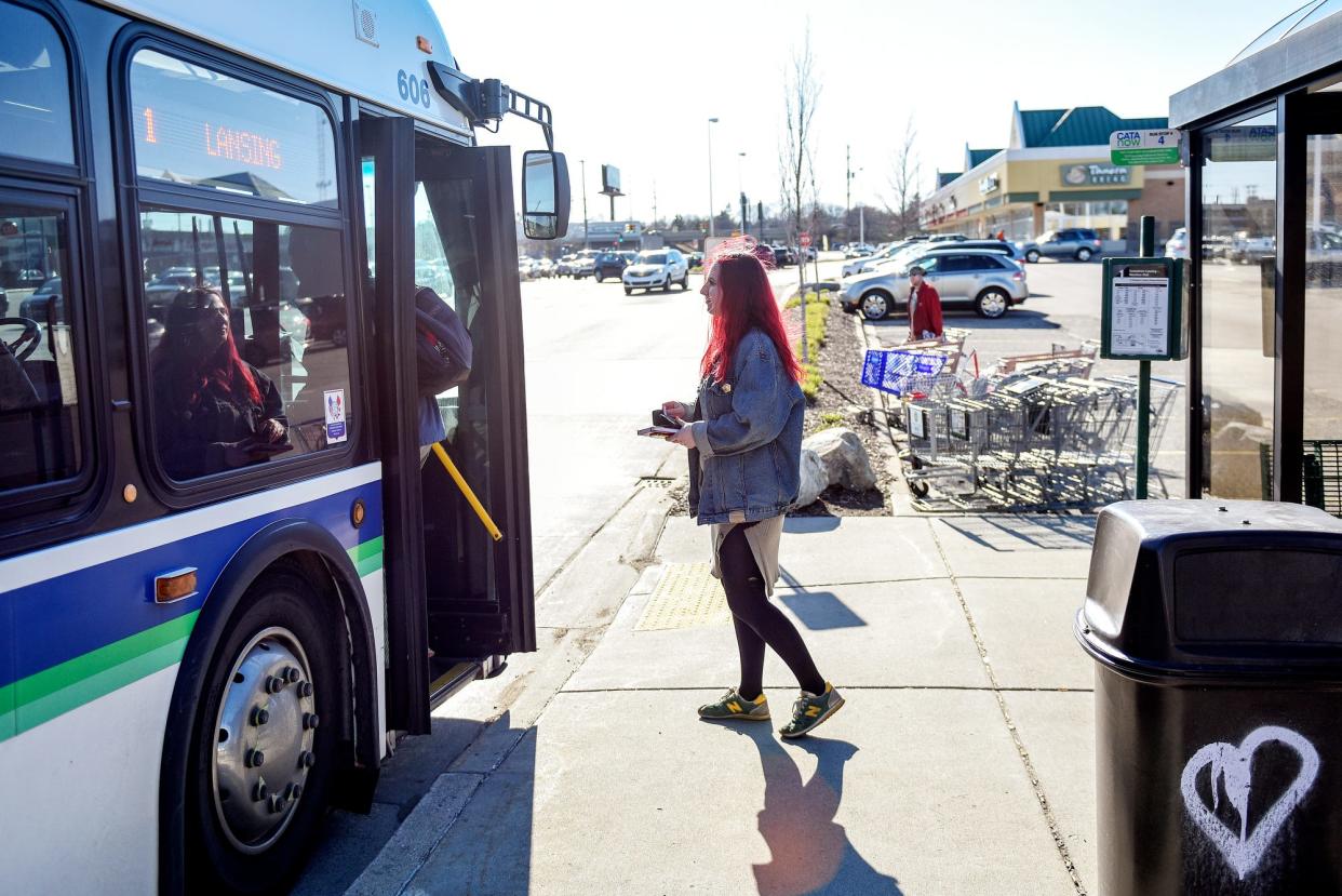 Lansing resident Ellen Dowling gets on a bus at a Capital Area Transportation Authority bus stop in Frandor on April 15, 2019, in Lansing. Frandor is eliminating two of CATA's bus stops at the center.