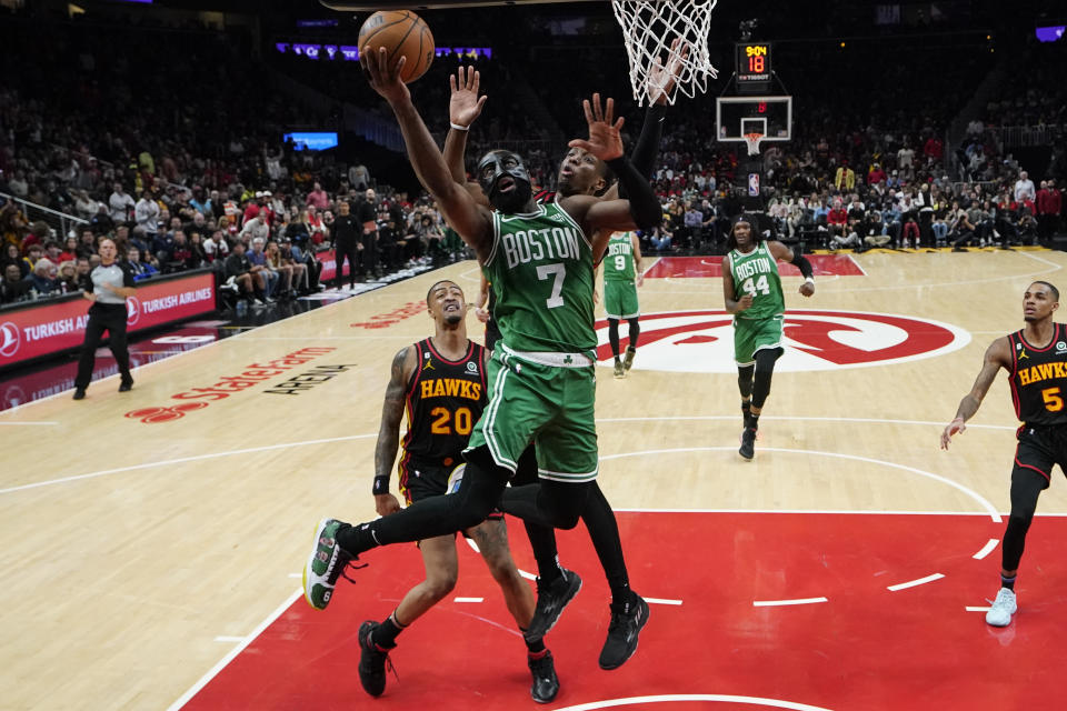 Boston Celtics' Jaylen Brown (7) shoots and scores against Atlanta Hawks' Onyeka Okongwu (17) during the second half of Game 6 of a first-round NBA basketball playoff series, Thursday, April 27, 2023, in Atlanta. (AP Photo/Brynn Anderson)