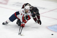 Washington Capitals defenseman Nick Jensen (3) and Arizona Coyotes right wing Clayton Keller, right, battle for the puck during the first period of an NHL hockey game Saturday, Feb. 15, 2020, in Glendale, Ariz. (AP Photo/Ross D. Franklin)