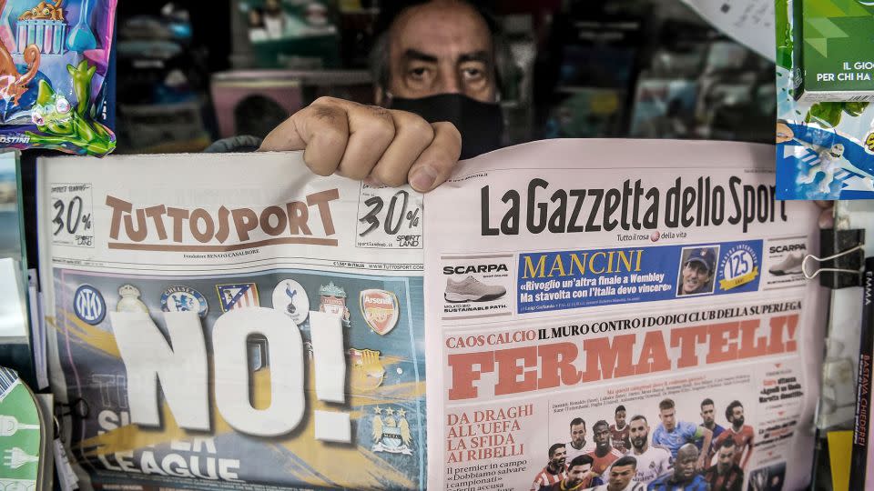 A newsagent shows two pages of the main Italian sports newspapers with a headline regarding the Super League reading 'No!' and 'Fermateli!' ('Stop them!) on April 20, 2021, in Livorno, Italy. - Laura Lezza/Getty Images