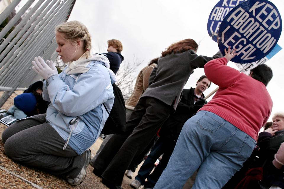 Kristin Costanza, left, a student at Mount Saint Mary's University in Emmitsburg, MD, prays in front of the Supreme Court during the March for Life to mark the 33rd anniversary of the landmark Supreme Court case Roe v. Wade Jan. 23, 2006 in Washington, D.C.