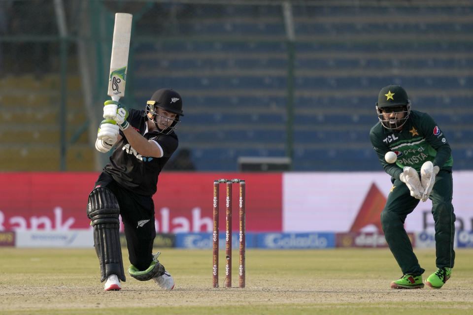 New Zealand's Tom Latham, left, plays a shot as Pakistan's Mohammad Rizwan watches during the first one-day international cricket match between Pakistan and New Zealand, in Karachi, Pakistan, Monday, Jan. 9, 2023. (AP Photo/Fareed Khan)