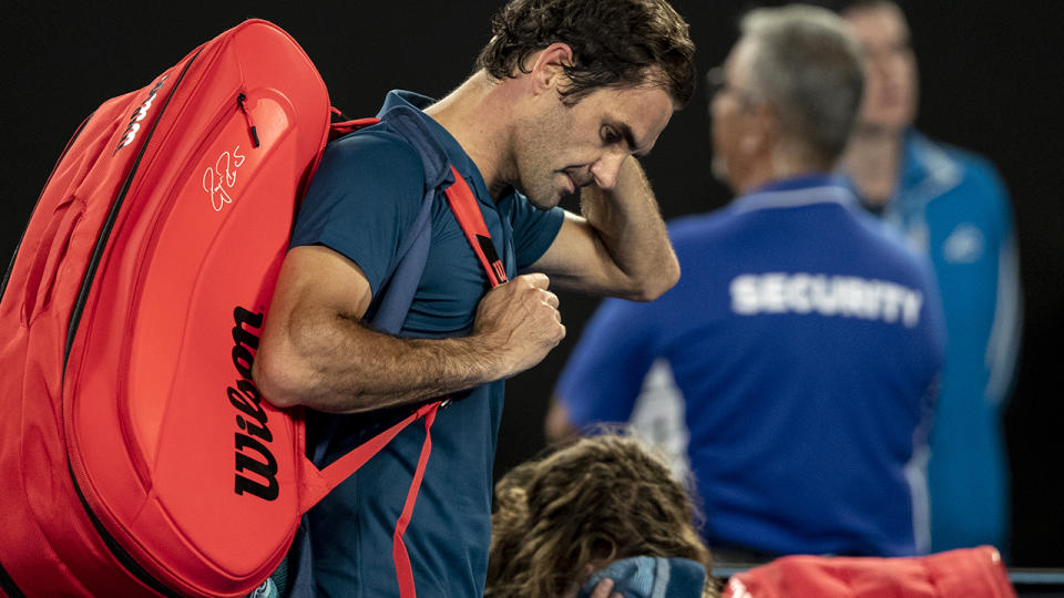 Roger Federer walks off Rod Laver Arena. (Photo by Fred Lee/Getty Images)