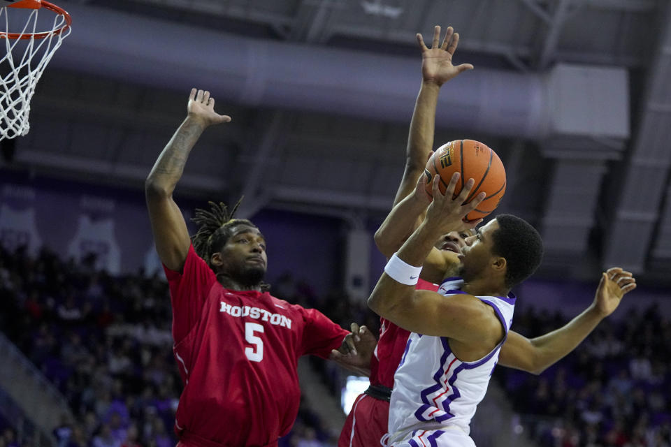 TCU guard Jameer Nelson Jr., right, goes up for a shot agains Houston forward Ja'Vier Francis (5) and guard L.J. Cryer during the first half of an NCAA college basketball game, Saturday, Jan. 13, 2024, in Fort Worth, Texas. (AP Photo/Julio Cortez)