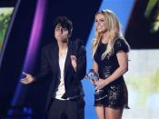 Lady Gaga, left, presents Britney Spears with the Video Vanguard award at the MTV Video Music Awards on Sunday Aug. 28, 2011, in Los Angeles. (AP Photo/Matt Sayles)