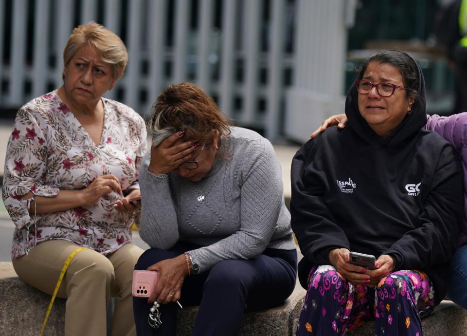People sit outside in Mexico City following a magnitude 7.6 earthquake on Monday afternoon.