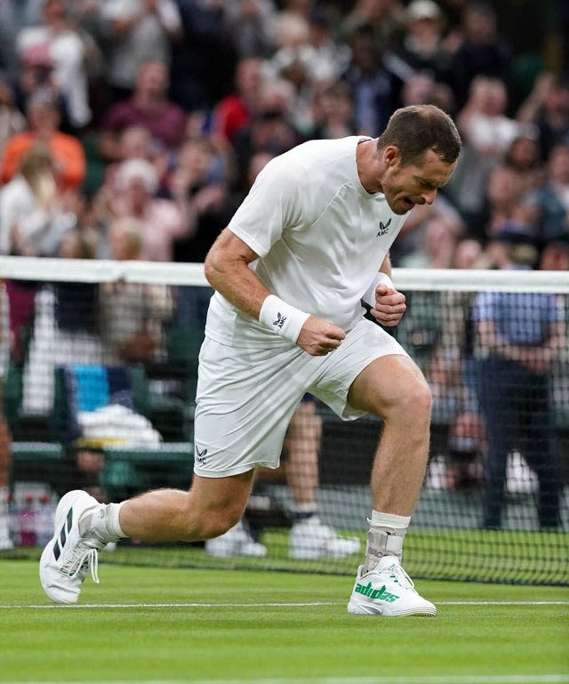 Andy Murray clenches his fists after booking his spot in round two 