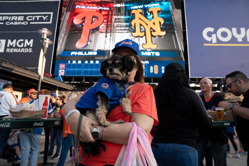 Keri Pearlson holds Russell during a Mets vs.Phillies game at Citi Field on Wednesday, May 31, 2023.