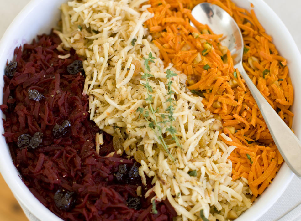 This Nov. 18, 2013 photo shows, from left, shredded beets with balsamic, shredded parsnips with walnuts, and shredded spicy carrots, in Concord, N.H. (AP Photo/Matthew Mead)