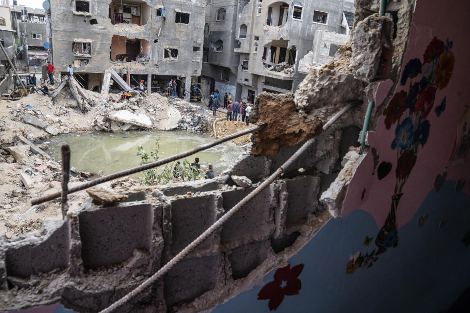 A crater full of water and sewage remains where the home of Ramez al-Masri was destroyed by an air-strike prior to a cease-fire reached after an 11-day war between Gaza's Hamas rulers and Israel, Sunday, May 23, 2021, in Beit Hanoun, the northern Gaza Strip. (AP Photo/John Minchillo)