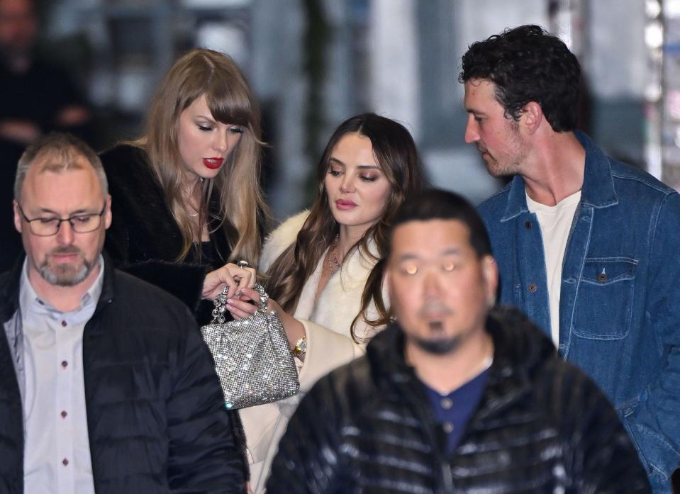 Taylor Swift, Keleigh Teller, and Miles Teller look at her opal ring.