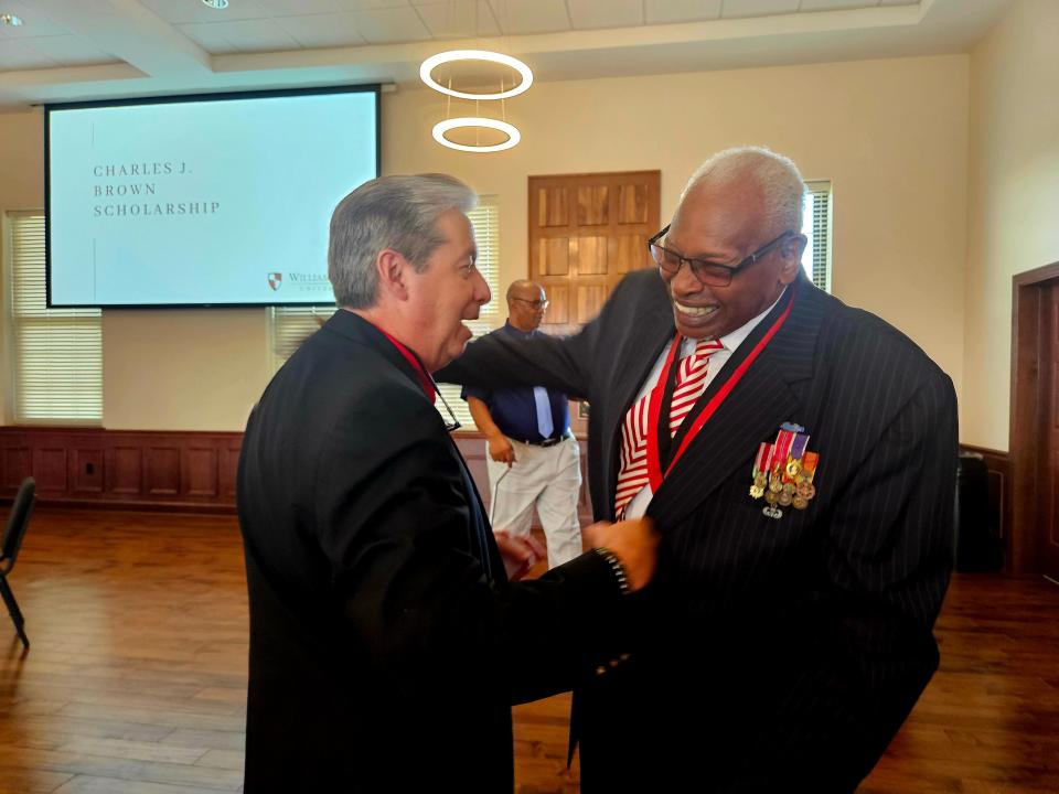 Hattiesburg residents Russ Hendley and Charles Brown share a moment of laughter during a reception Wednesday announcing the Charles J. Brown endowed scholarship at William Carey University.