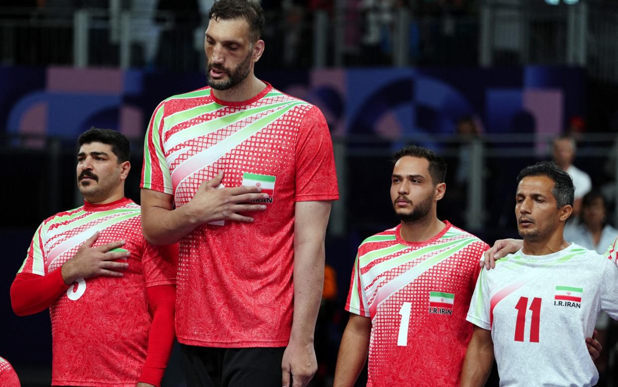 Morteza Mehrzadselakjani with his teammates before a sitting volleyball match at the Paris Paralympics