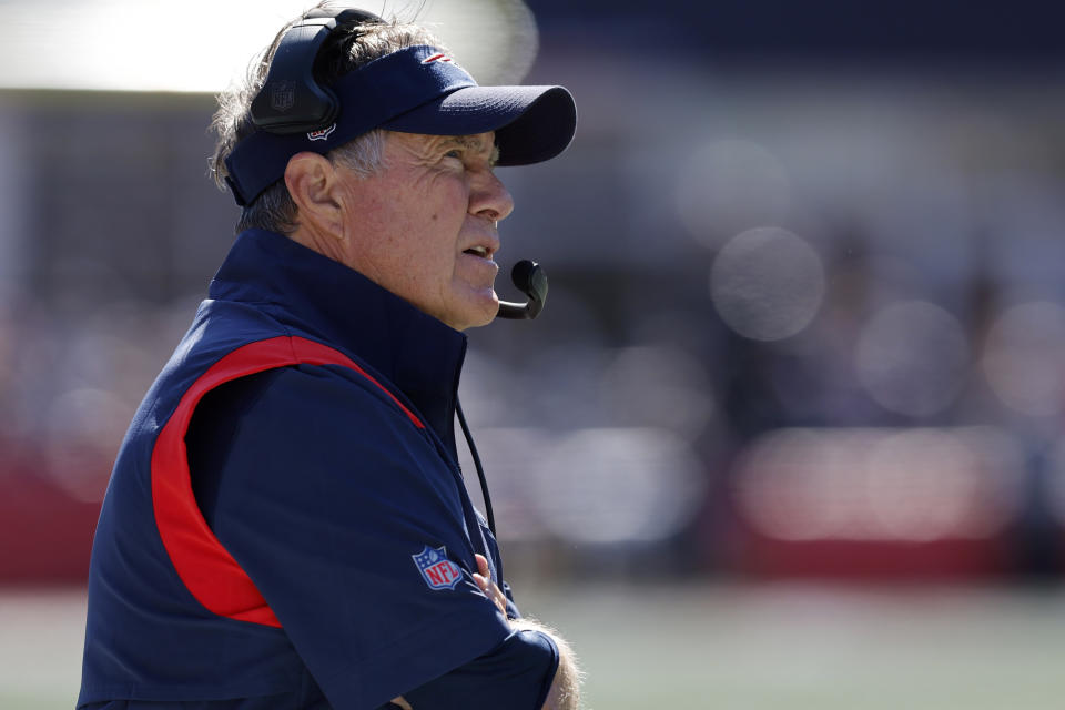 New England Patriots head coach Bill Belichick speaks in a microphone on the sideline during the first half of an NFL football game against the Detroit Lions, Sunday, Oct. 9, 2022, in Foxborough, Mass. (AP Photo/Michael Dwyer)