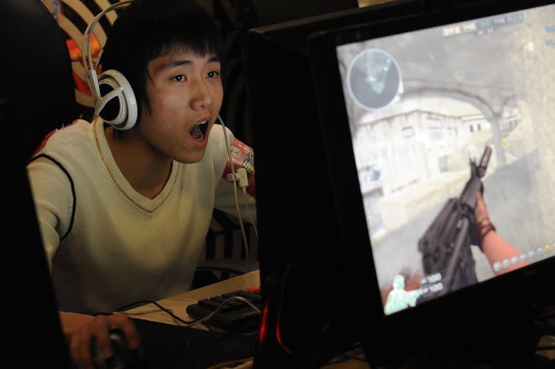 A gamer plays online games at an internet cafe in Taiyuan