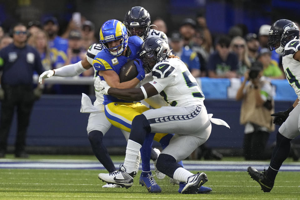 Los Angeles Rams wide receiver Cooper Kupp, left, is tackled while running the ball during the first half of an NFL football game Sunday, Nov. 19, 2023, in Inglewood, Calif. (AP Photo/Mark J. Terrill)
