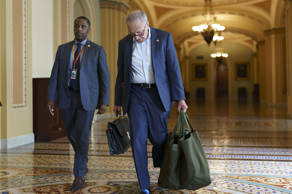 Senate Majority Leader Chuck Schumer, D-N.Y., carries his baggage as he arrives at the Capitol in Washington, Monday, June 7, 2021, after a ten-day recess. As Democrats strain to deliver on President Joe Biden's agenda, Schumer has warned colleagues that June will 