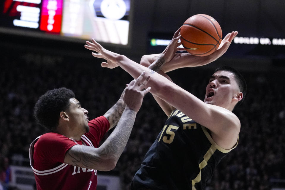 Indiana center Kel'el Ware (1) fouled Purdue center Zach Edey (15) as he shoots during the second half of an NCAA college basketball game in West Lafayette, Ind., Saturday, Feb. 10, 2024. (AP Photo/Michael Conroy)