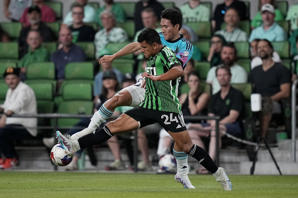 Minnesota United midfielder Sang Bin Jeong and Austin FC defender Nick Lima (24) compete for control of the ball during the second half of an MLS soccer match Wednesday, May 31, 2023, in Austin, Texas. (AP Photo/Eric Gay)
