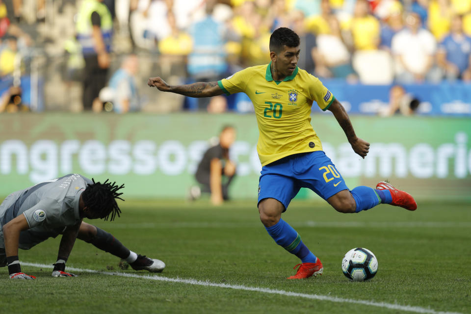 Brazil's Roberto Firmino scores his side's second goal against Peru during a Copa America Group A soccer match at the Arena Corinthians in Sao Paulo, Brazil, Saturday, June 22, 2019. (AP Photo/Victor R. Caivano)