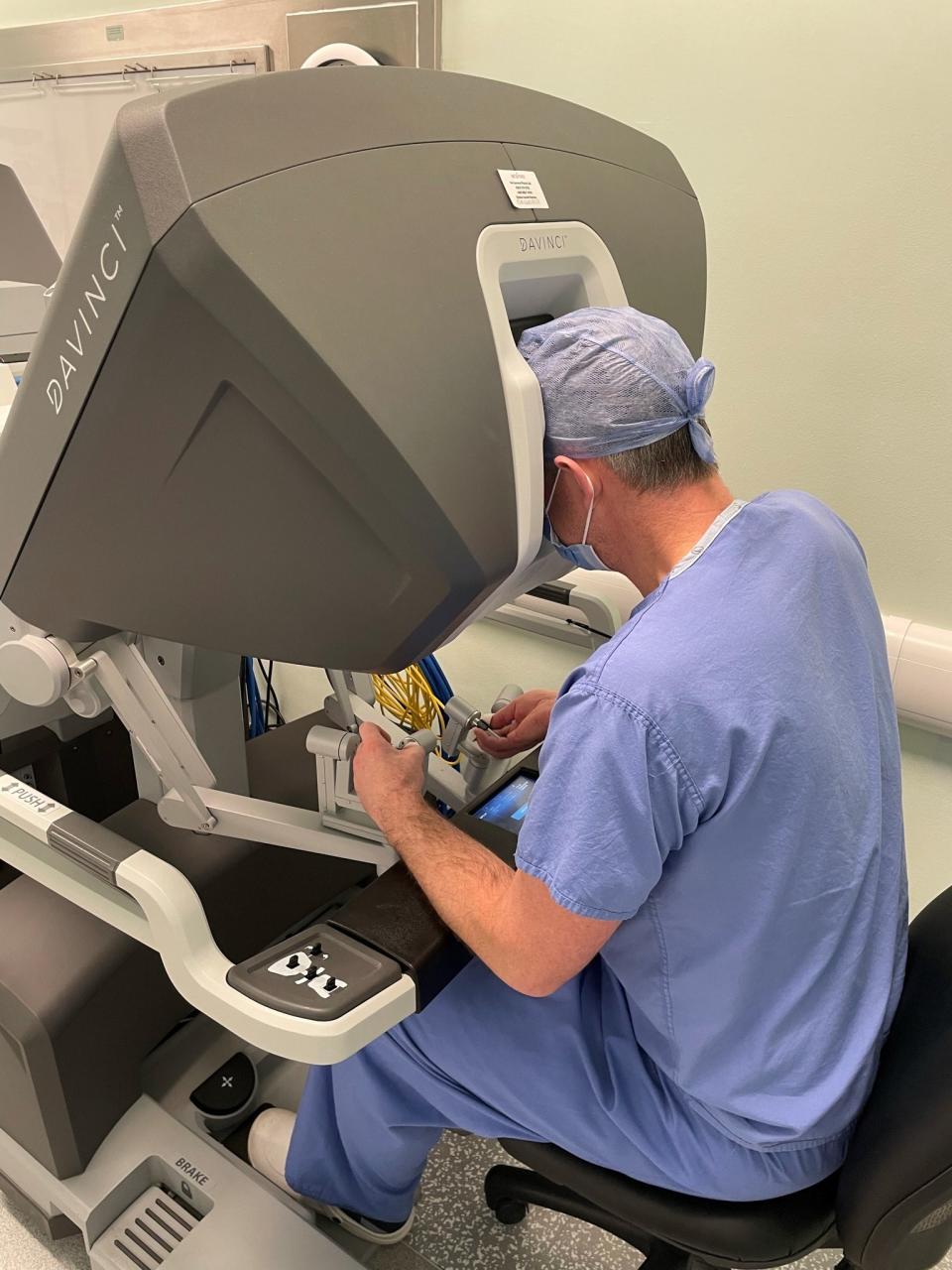 A surgeon at one of the consoles used in robotic surgery (NHS Greater Glasgow and Clyde/PA)