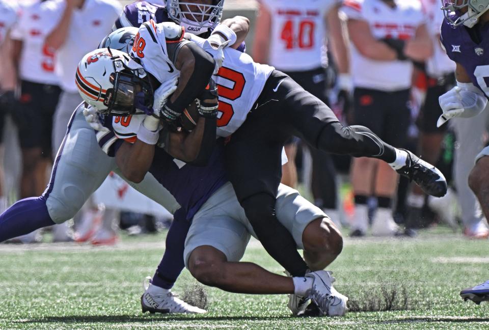 MANHATTAN, KS - SEPTEMBER 28: Cornerback Jacob Parrish #10 of the Kansas State Wildcats tackles wide receiver Brennan Presley #80 of the Oklahoma State Cowboys in the first half at Bill Snyder Family Football Stadium on September 28, 2024 in Manhattan, Kansas. (Photo by Peter Aiken/Getty Images)