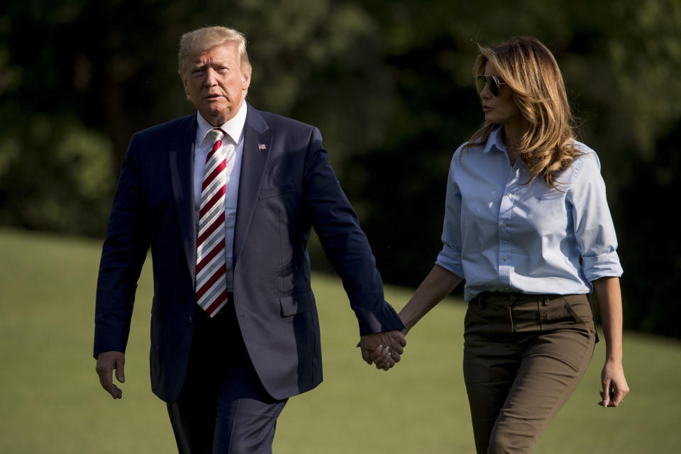 President Donald Trump and first lady Melania Trump walk across the South Lawn of the White House in Washington, Sunday, Aug. 4, 2019, as they arrive back from Bedminster, N.J. (AP Photo/Andrew Harnik)