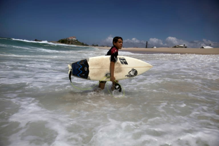 Rickson Falcao, 10, who spends half of every day riding the waves, dreams of becoming world surfing champion