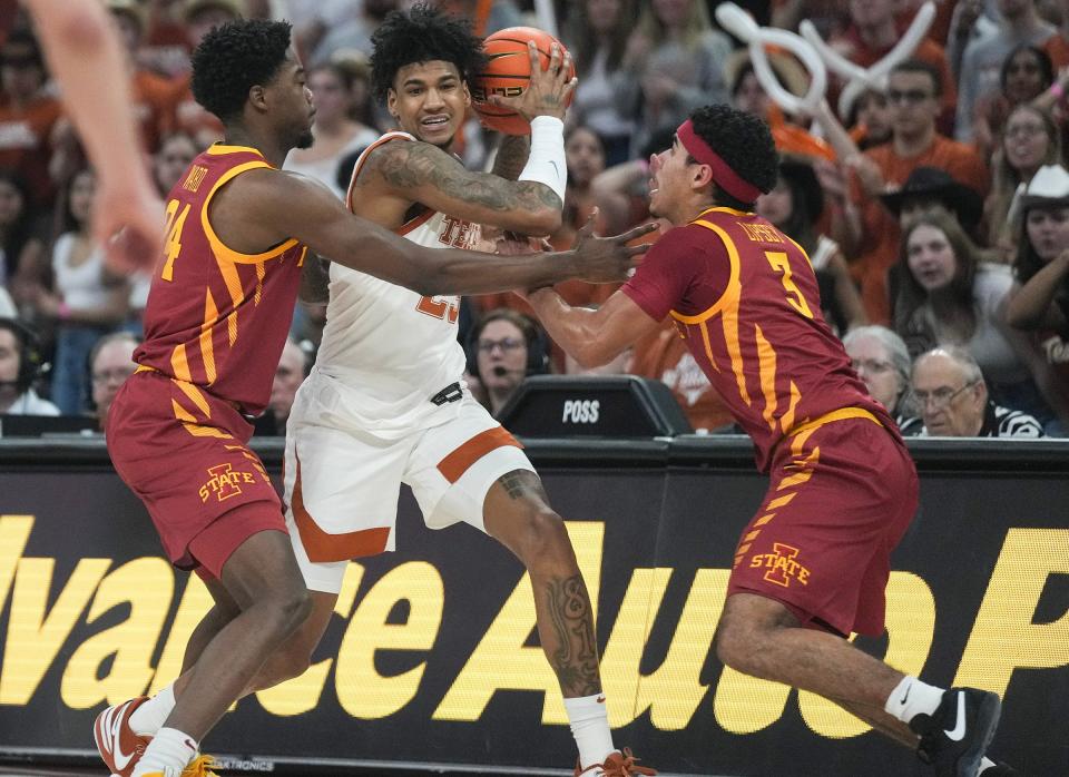 Texas forward Dillon Mitchell tries to escape a double-team from Iowa State in Tuesday's Big 12 contest at Moody Center. Iowa State held on for a 70-65 win.