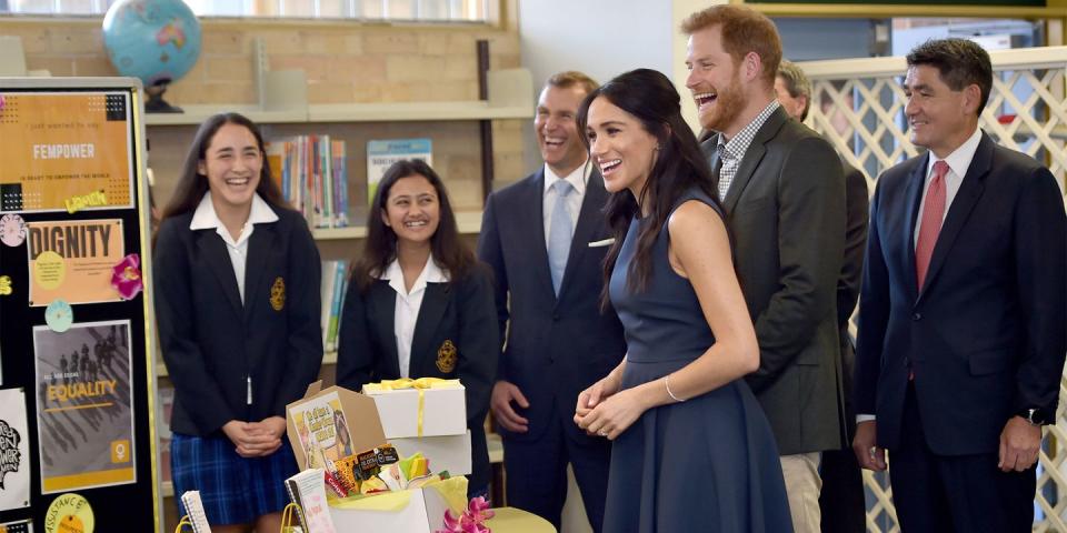 <p>Meghan wears <a rel="nofollow noopener" href="https://www.net-a-porter.com/us/en/product/1091277/Roksanda/athena-pleated-two-tone-crepe-midi-dress?cm_mmc=LinkshareUK-_-TnL5HPStwNw-_-Custom-_-LinkBuilder&siteID=TnL5HPStwNw-2oF7kLeE13FGdxPo7PUoJw&Skimlinks.com=Skimlinks.com&dclid=CKzQ4I_Yl94CFQ_E3godeAMEnQ" target="_blank" data-ylk="slk:Roksanda's Athena pleated two-tone crepe midi dress;elm:context_link;itc:0;sec:content-canvas" class="link ">Roksanda's Athena pleated two-tone crepe midi dress</a>.</p>