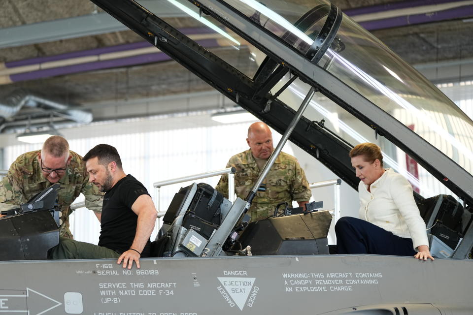 Ukrainian President Volodymyr Zelenskyy, left, and Denmark's Prime Minister Mette Frederiksen sit in a F-16 fighter jet at Skrydstrup Airbase, in Vojens, Denmark, Sunday, Aug. 20, 2023. (Mads Claus Rasmussen/Ritzau Scanpix via AP)