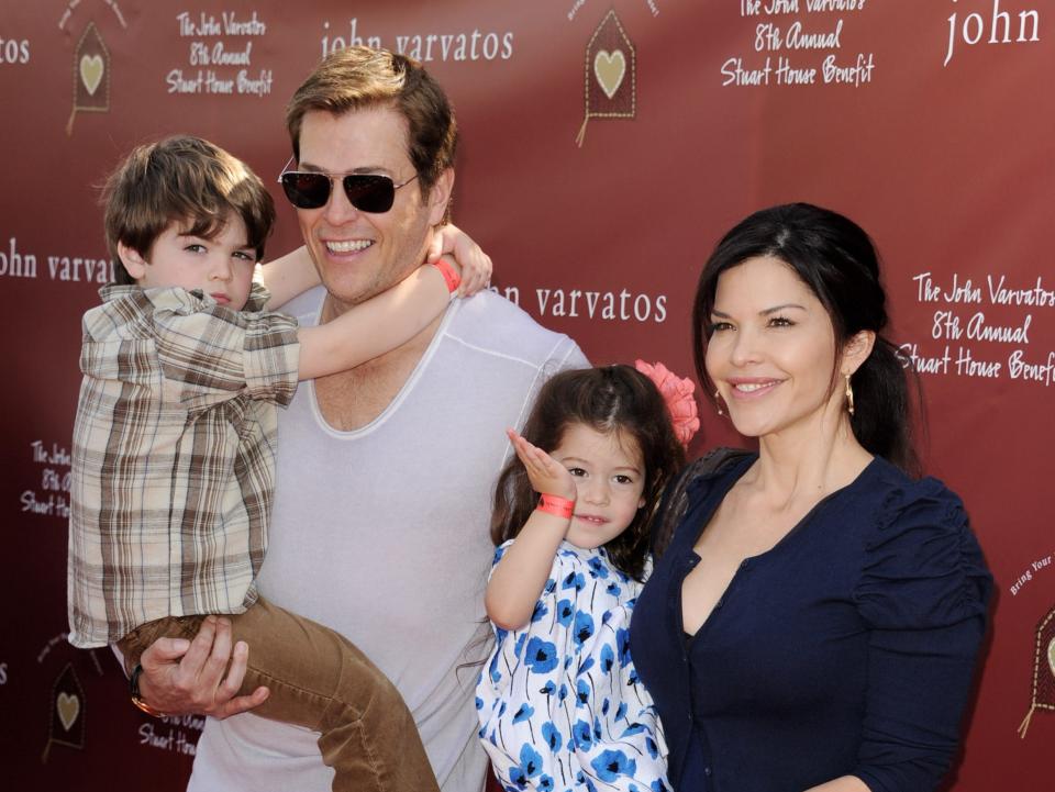 Patrick Whitesell and Lauren Sanchez holding their children, Evan and Ella, in 2011.