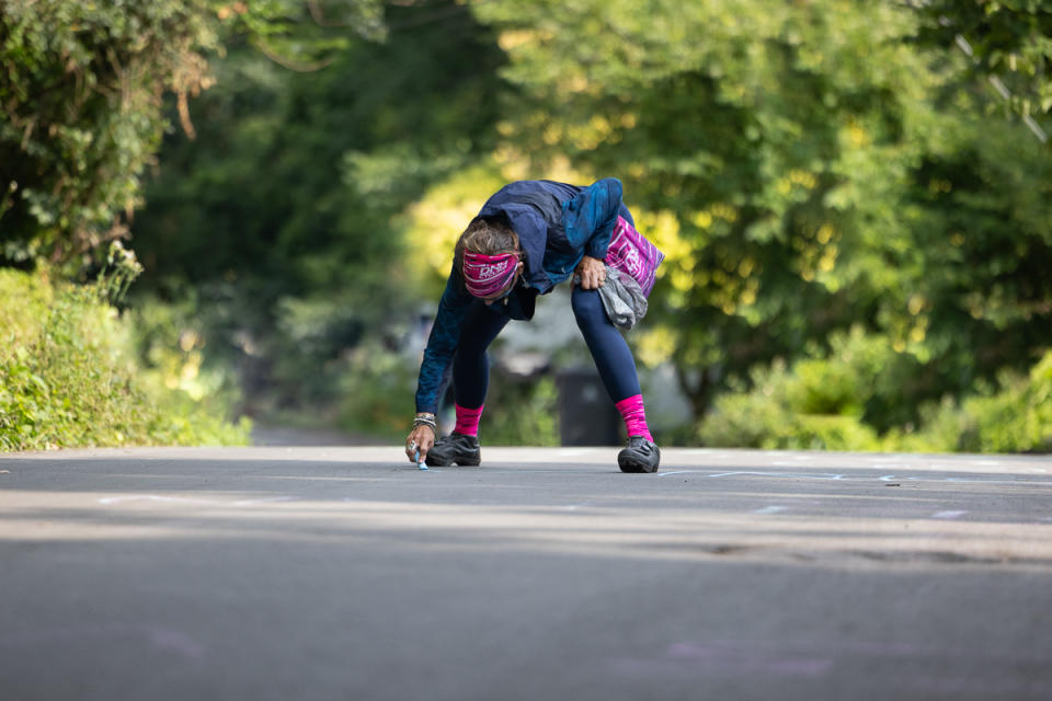 Shayna Powless's Mom, a big DNA Pro Cycling fan brought chalk to write the names of her favorite team on the slopes of Sherod.