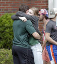 <p>Students hug outside a staging area at the First Baptist Church of Ocala after a shooting incident at nearby Forest High School, Friday, April 20, 2018, in Ocala, Fla. (Photo:John Raoux/AP) </p>