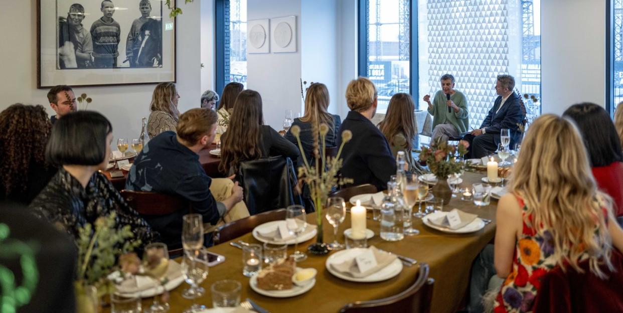 restaurant full of people watching a talk